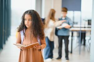 Portrait of cute African-American girl at school photo