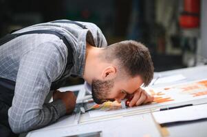 Print house worker controlling printing process quality and checking colors with magnifying glass photo