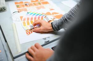 Typographer standing with color swatches at the printing manufacturing photo