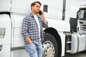 Indian truck driver tending a client on the phone. photo