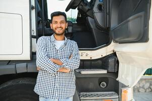 Young Indian truck driver. Concept of road freight transportation. photo