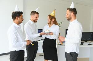 corporate party and people concept - happy team with cake celebrating colleague birthday at office photo