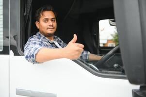 Young Indian truck driver. Concept of road freight transportation photo