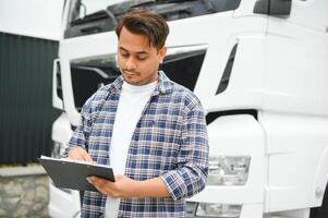 Young Indian truck driver. Concept of road freight transportation photo