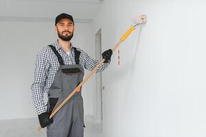 joven trabajador haciendo reparar en habitación. foto