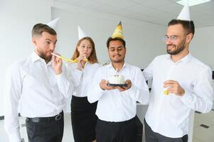 business team celebrating a birthday in the office. photo