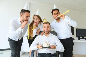 corporate party and people concept - happy team with cake celebrating colleague birthday at office photo