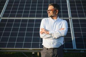 Architect standing by solar panels. photo