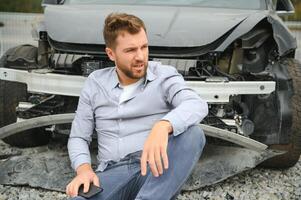 Car accident. Man after car accident. Man regrets damage caused during car wreck photo