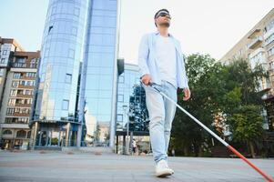 Blind man with a walking stick. photo