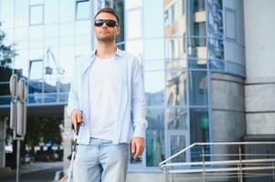 Blind man. Visually impaired man with walking stick, photo