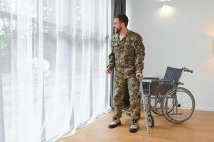 Soldier trying to get up from the wheelchair. photo