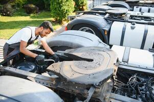 Indian Mechanic repairing the truck photo