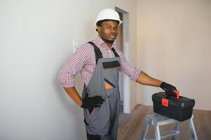 Young cheerful African American repairman photo