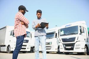 Logistics manager controlling truck driver schedule photo