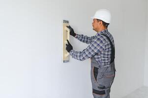 Worker make repairs in new apartment photo