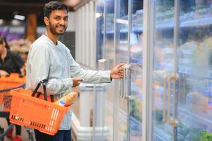 portrait of indian male in grocery with positive attitude photo