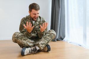 Crying professional soldier with depression and trauma after war photo