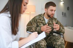 Talking to doctor. Soldier have therapy session with psychologist indoors photo