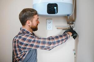 worker set up central gas heating boiler at home photo