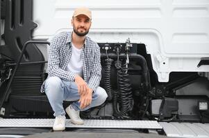 View of a driver connecting the power cables to trailer of a commercial truck photo