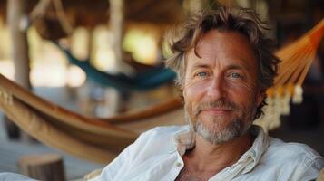 A man happily sits in a hammock photo