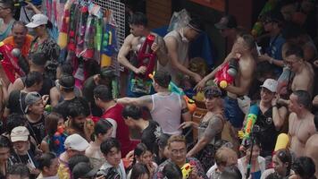 Bangkok, Thailand, April 13, 2024 - Thai New Year or Songkran Festival Thousands of People Gather at Silom Road Water Fight Splash with Water Gun video