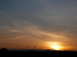 Spectacular sunset over, orange sun rising up over the horizon photo