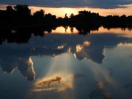 Spectacular sunset over, orange sun rising up over the horizon photo