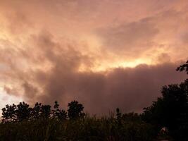 Spectacular sunset over, orange sun rising up over the horizon photo