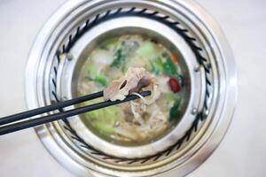 comiendo Sukiyaki ,suki o shabu maceta foto