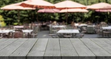 empty pine wood table top with blurry background, blank counter for product montage advertising photo