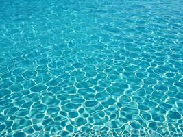 Seamless background pattern of crystal clear transparent blue water photo