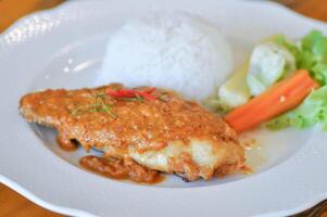 stir fried fish with chili ,sauce and rice or a king of curry cooked with fried fish served with a spicy sauce photo