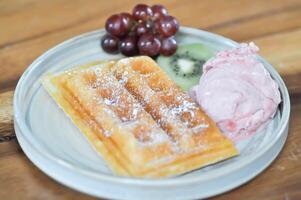 waffle with ice cream and fruit topping photo