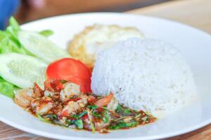 stir fried shrimp with holy basil and sunny side up egg or fried egg photo