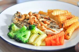 grilled chicken or chicken steak with gravy sauce , French fries and vegetable photo