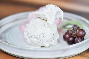 ice cream and fruit , vanilla ice cream or sesame ice cream with grape and kiwi fruit photo