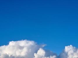 White fluffy cumulus clouds in the summer sky, natural clouds background photo