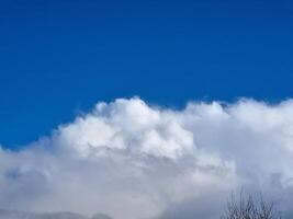 White fluffy cumulus clouds in the summer sky, natural clouds background photo