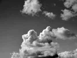 Black and white clouds in the sky background photo