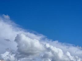 White fluffy cumulus clouds in the summer sky, natural clouds background photo