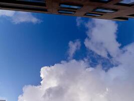 White cumulus clouds in the deep blue summer sky. Fluffy clouds background photo