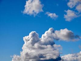 Cumulus clouds in the sky. Fluffy cloud shapes photo