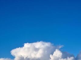 White fluffy cumulus clouds in the summer sky, natural clouds background photo