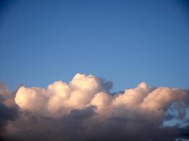 White fluffy cumulus clouds in the summer sky, natural clouds background photo