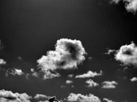 Black and white clouds in the sky background photo