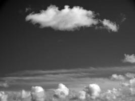 Black and white clouds in the sky background photo