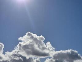 White fluffy cumulus clouds in the summer sky, natural clouds background photo