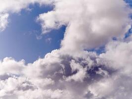 White fluffy cumulus clouds in the summer sky, natural clouds background photo